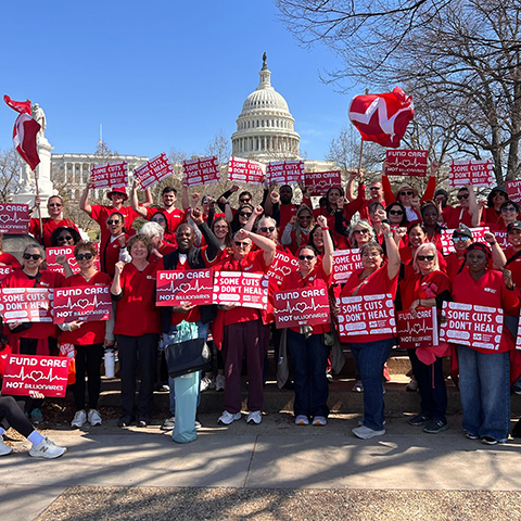 Nurses outside D.C. Capitol buidling holdisngs "Some Cuts Don't Heal"