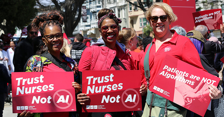 Three nurses side by side holding signs "Trust Nurses Not A.I." and "Patients are Not Algorithms"