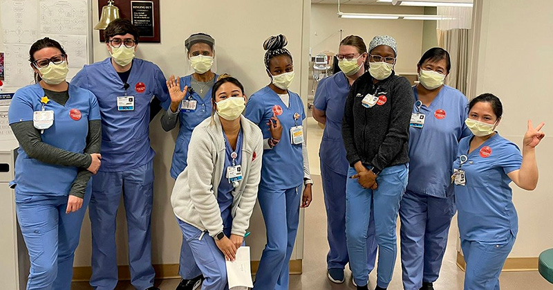Nurses inside hospital smiling