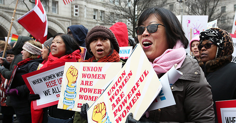 Nurses holding signs "Union Women are Powerful Women"