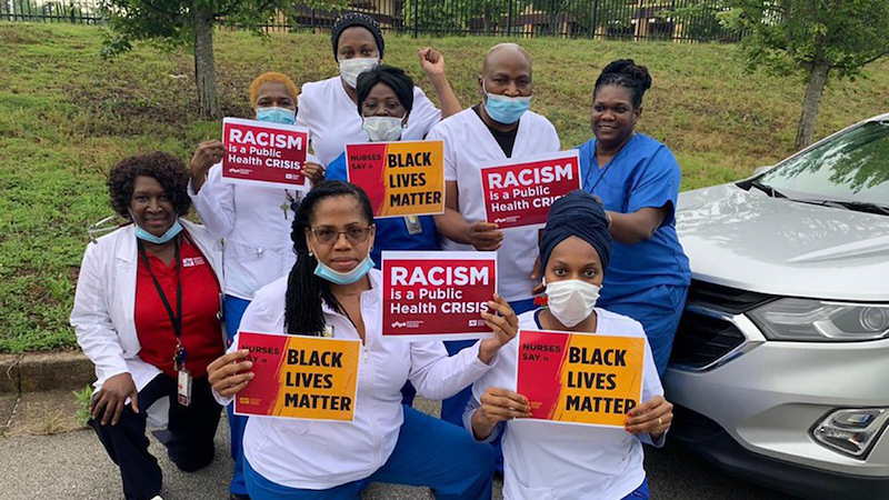 Nurses hold signs "Black Lives Matter"