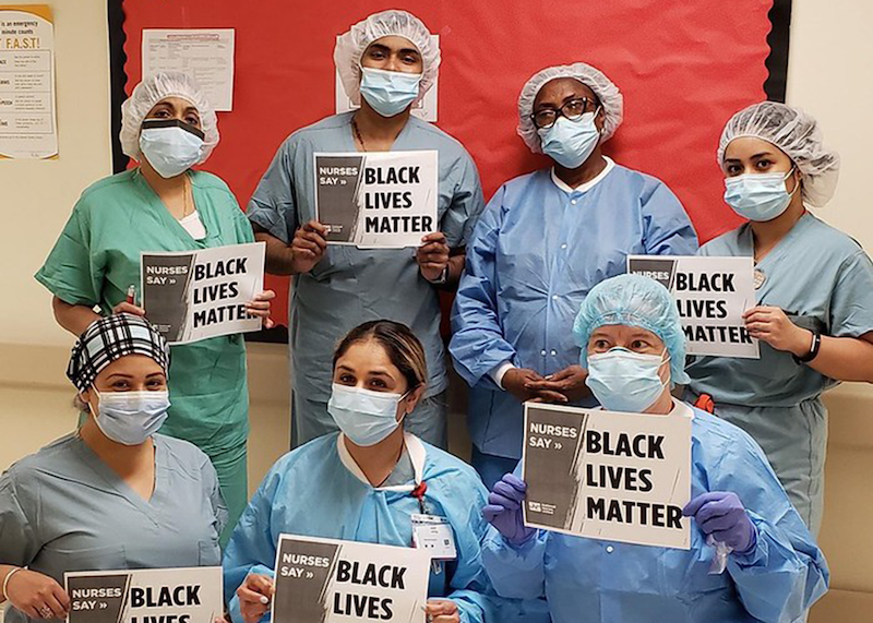 Nurses hold signs "Black Lives Matter"