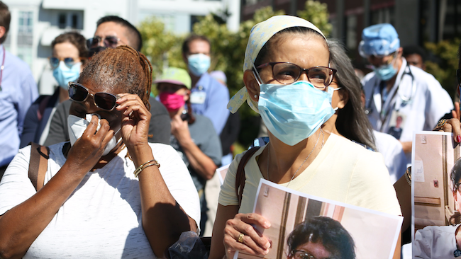 RNs at Alta Bates Summit Medical Center hold a photo of their colleague Janine Paiste-Ponder, RN.