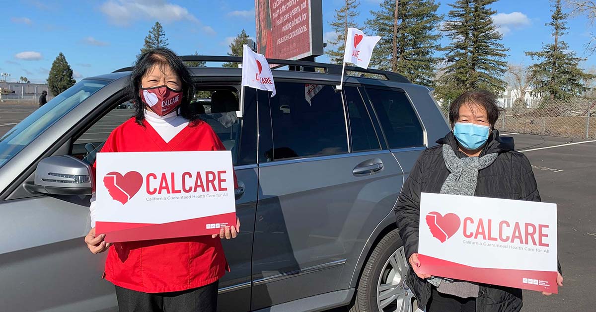 Nurses outside hold CalCare signs