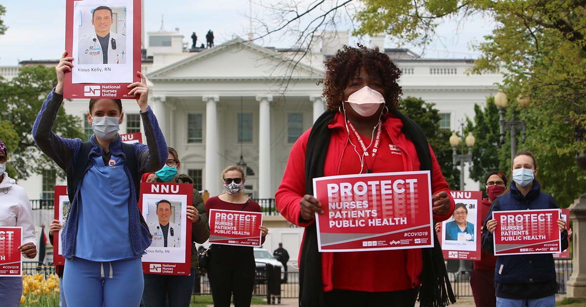 Nurses outside The White House hold signs "Protect Nurses, Patients, Public Health"