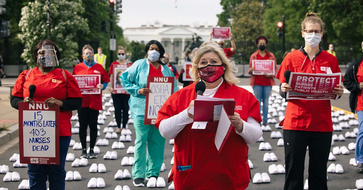 Nurses outside The White House holding signs calling for nurse, patient, and public safety