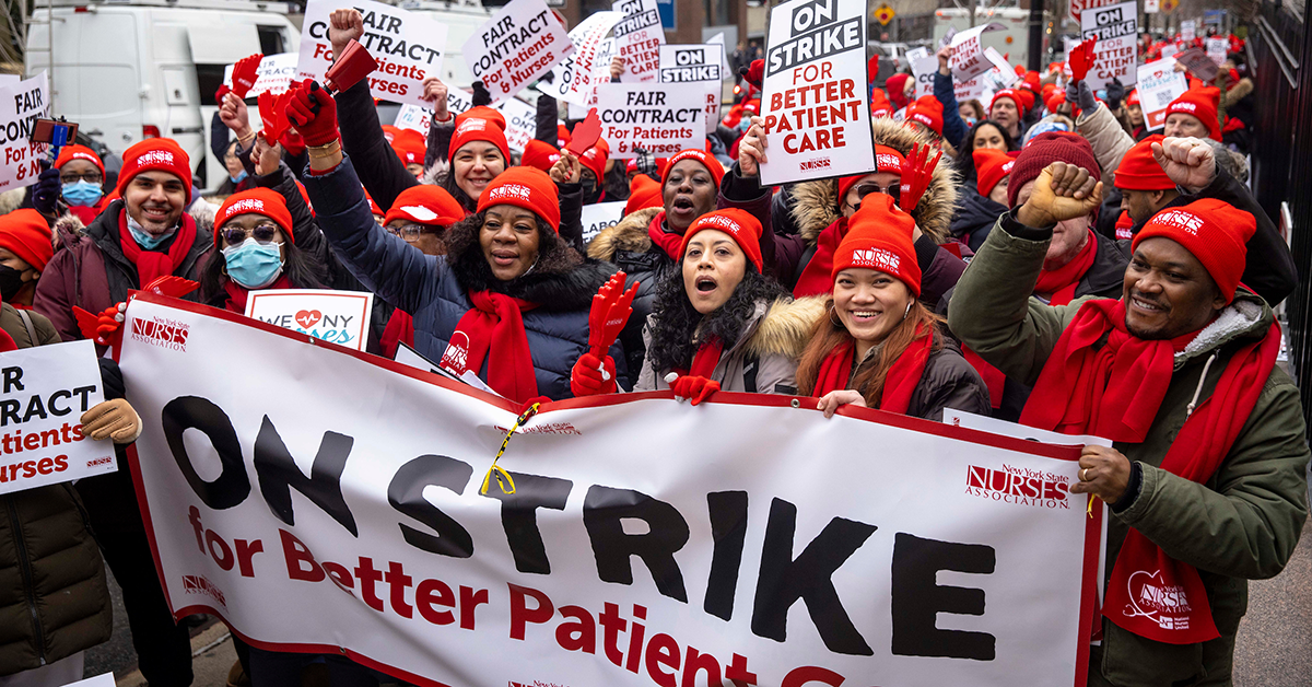 NYSNA nurses marching with signs and banners "On strike for better patient care"