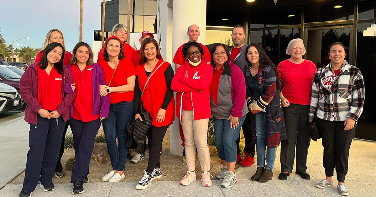 Large group of smiling nurses outside Desert Regional Medical Center