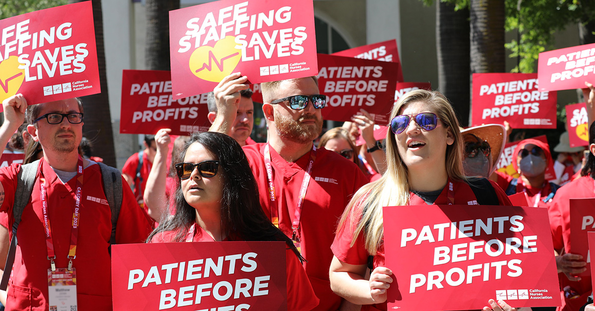 Nurses outside holding signs "Patients Before Profits" and "Safe Staffing Saves Lives"