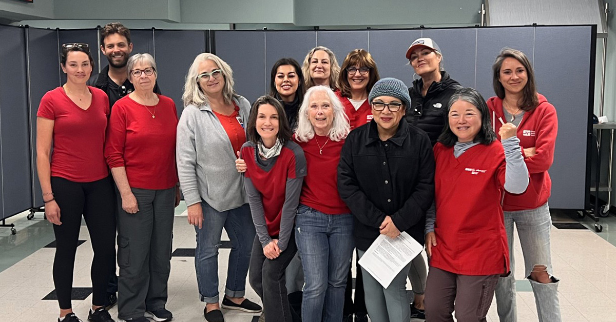 Large group of nurses inside hospital, smiling