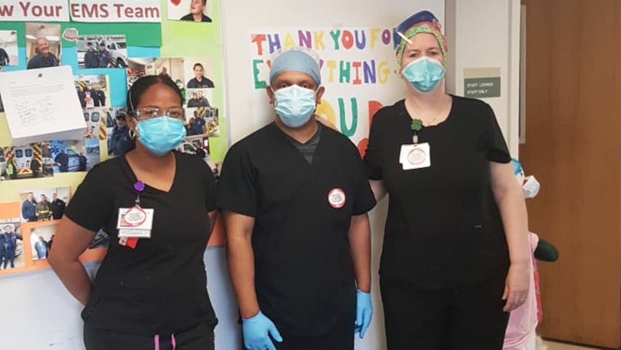 3 masked nurses in hallway