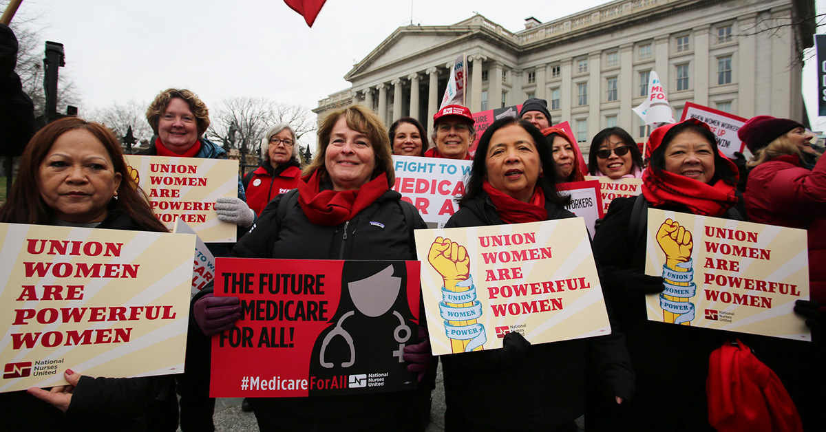 Group of nurses in march holding signs "Union women are powerful women"