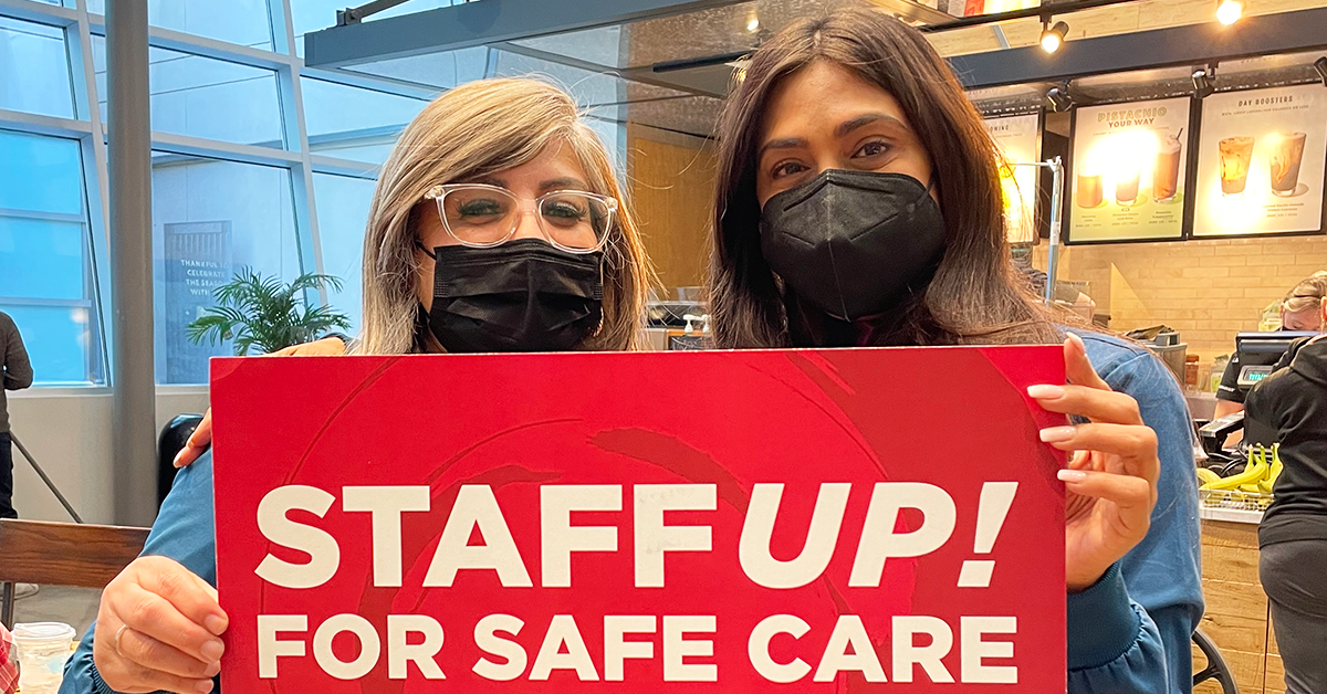 Two City of Hope nurses holding sign "Staff up! For safe care"