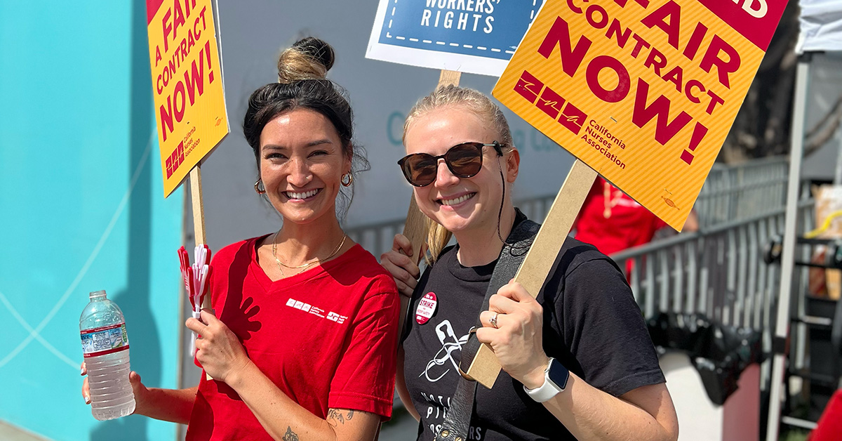 Two nurses on picket line smiling