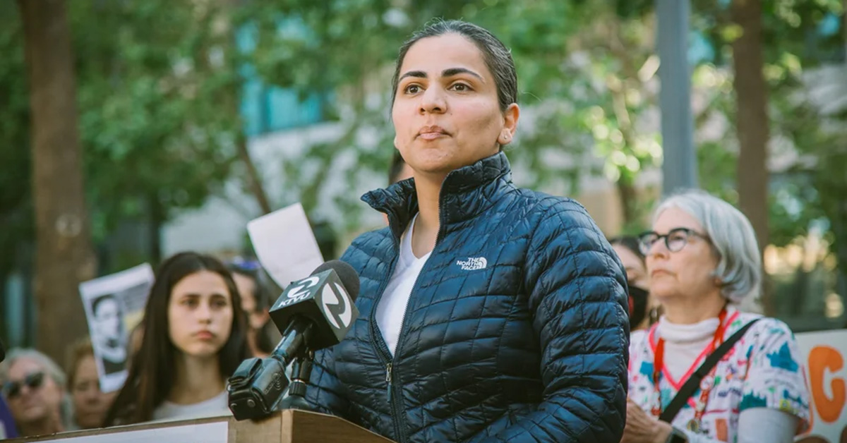 Dr. Aisha Wahab outside, at podium