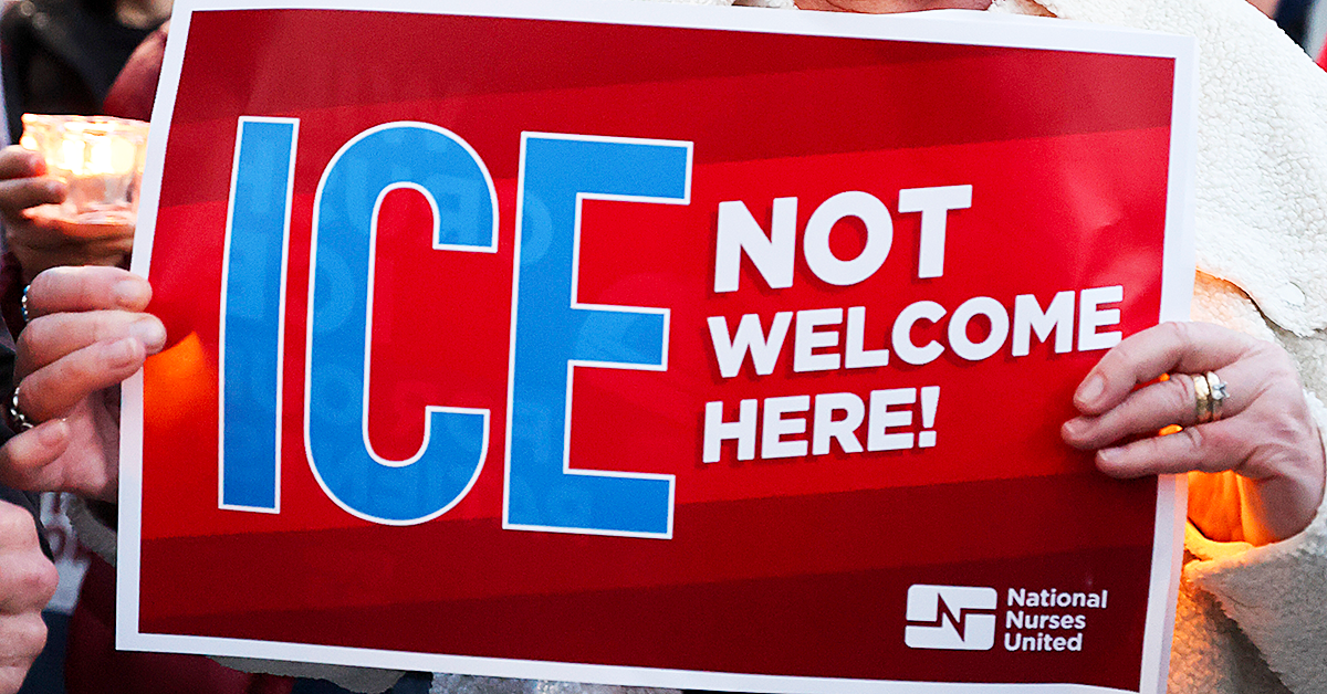 Hands holding sign "ICE NOT welcome here"