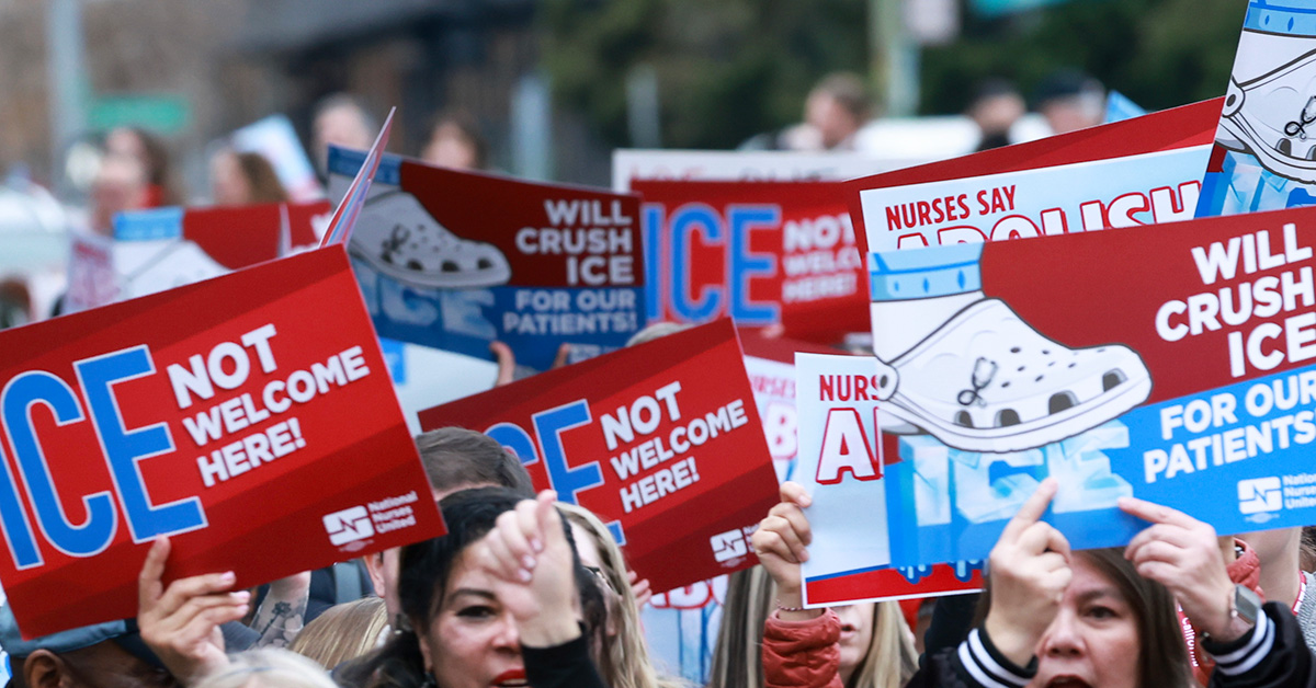 Marching hands holding signs "ICE Not Welcome Here" and "Will crush ICE for our patients"