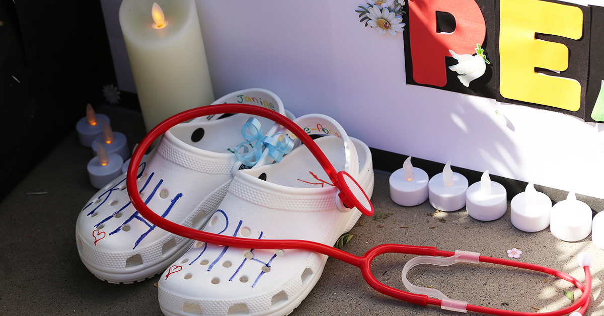 Candlight vigil with stethoscope and empty shoes