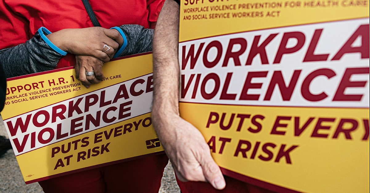 Nurses holding signs "Workplace Violence puts everyone at risk"