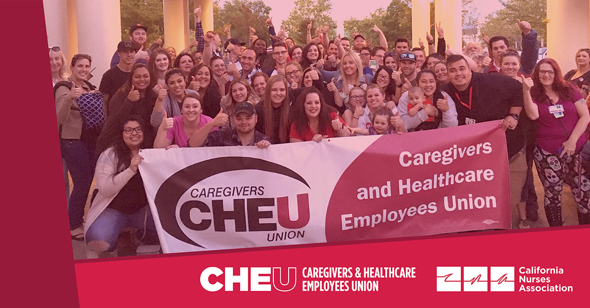 Large group of CHEU members holding banner, CHEU and CNA logos