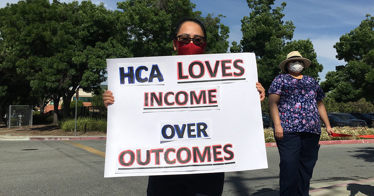 Nurse holds sign "HCA loves income over outcomes"