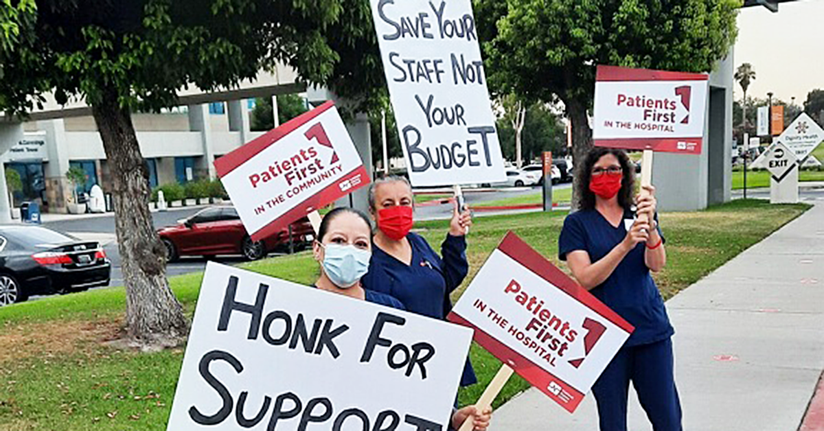 Nurses holding signs: "Honk for support" "Patients first in the hospital" and "Save your staff, not your budget"