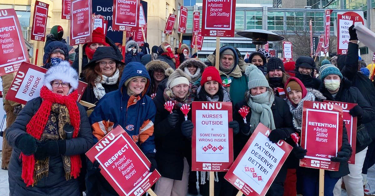 UChicago nurses hold up signs in support of safe staffing.