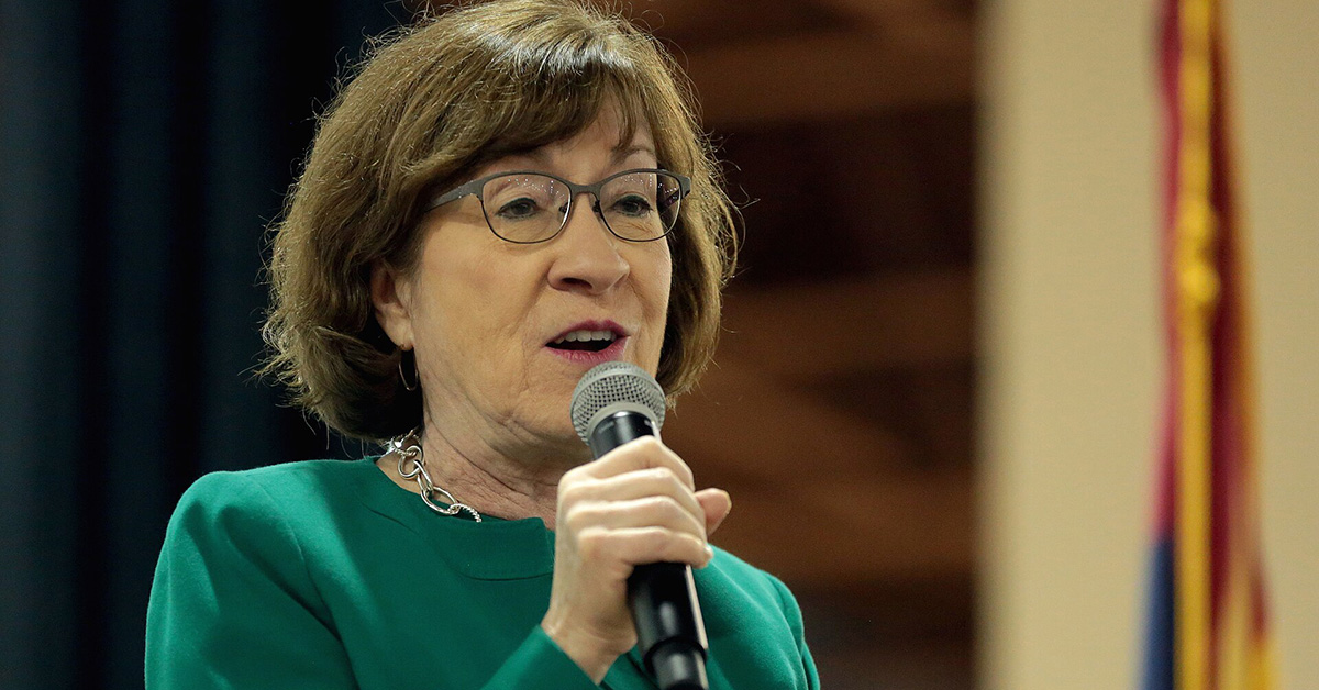 Susan Collins holding microphone