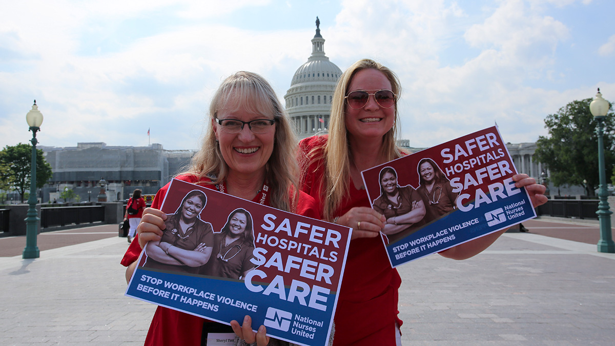 Nurses outside capitol building hold signs calling for safe workplaces