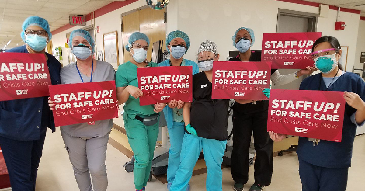 Large groups of nurses inside hospital hold signs "Staff Up for Safe Care"