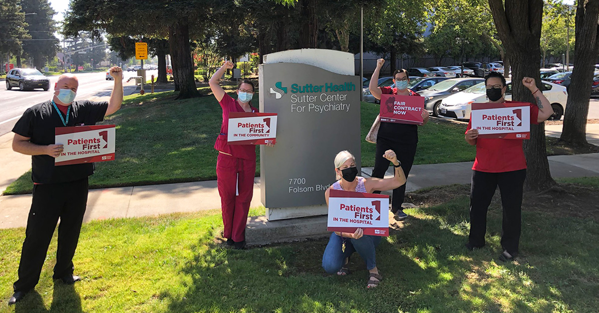 Group of nurses outside Sutter hospital with raised fists, holding signs "Patients First" and "Fair Contract Now"