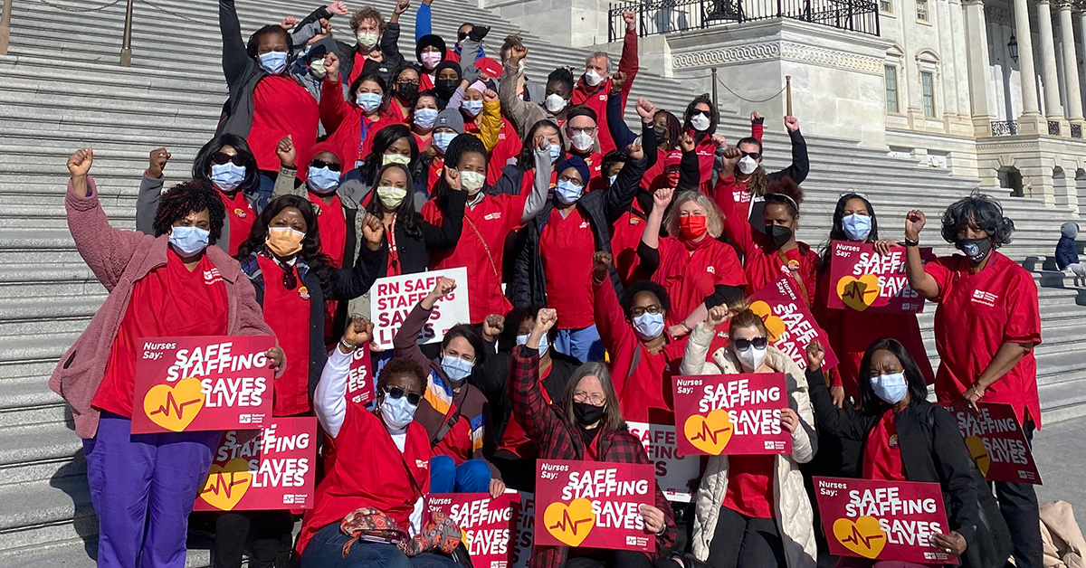 Nurses outside Capitol building with raised fists holding signs "Safe Staffing Saves Lives"