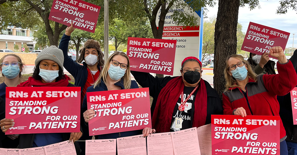 Nurses outside hold signs "RNs at Seton standing strong for our patients"