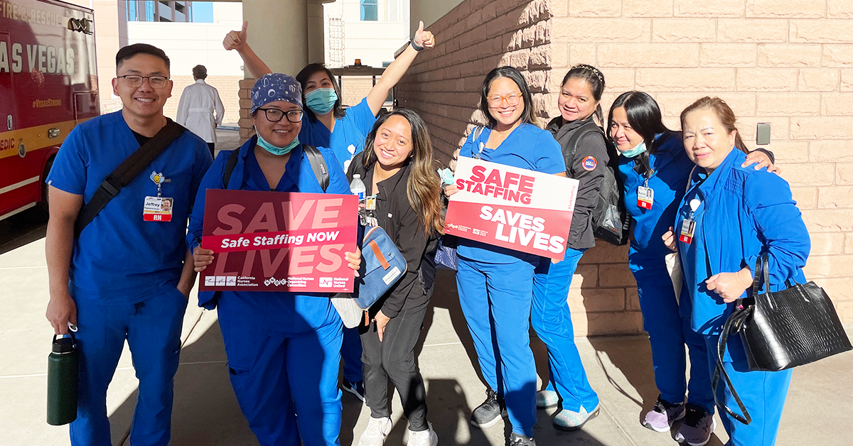 MountainView hospital nurses holding signs "Safe staffing. Save lives." and "Save lives. Safe staffing NOW."