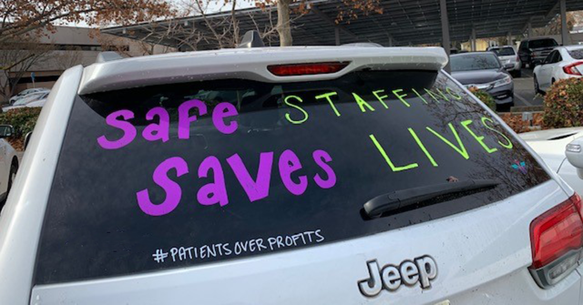 Back of car with "Safe Staffing Saves Lives" written on window