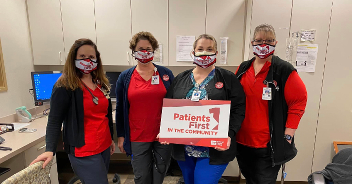 Enloe Medical Center RNs hold sign "Patients First in the Community"