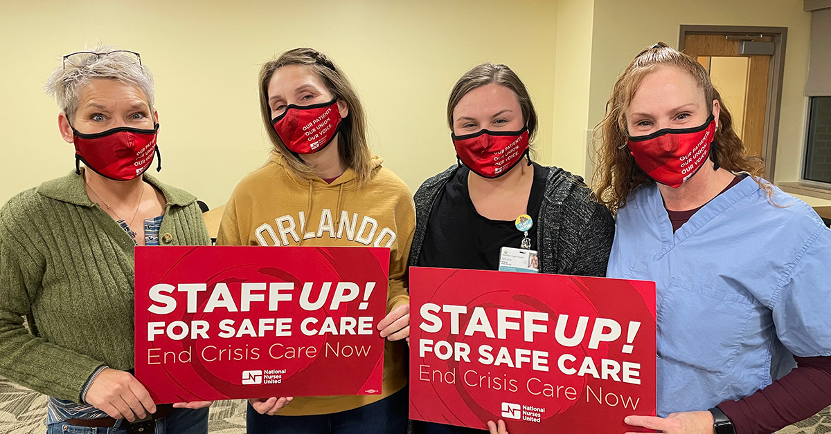 Four nurses inside hold signs "Staff Up for Safe Care"