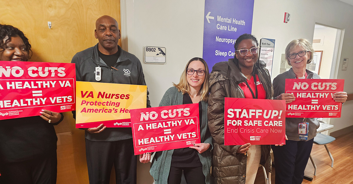 Nurses in hallway holding signs "No Cuts: A Healthy VA = Healthy Vets"