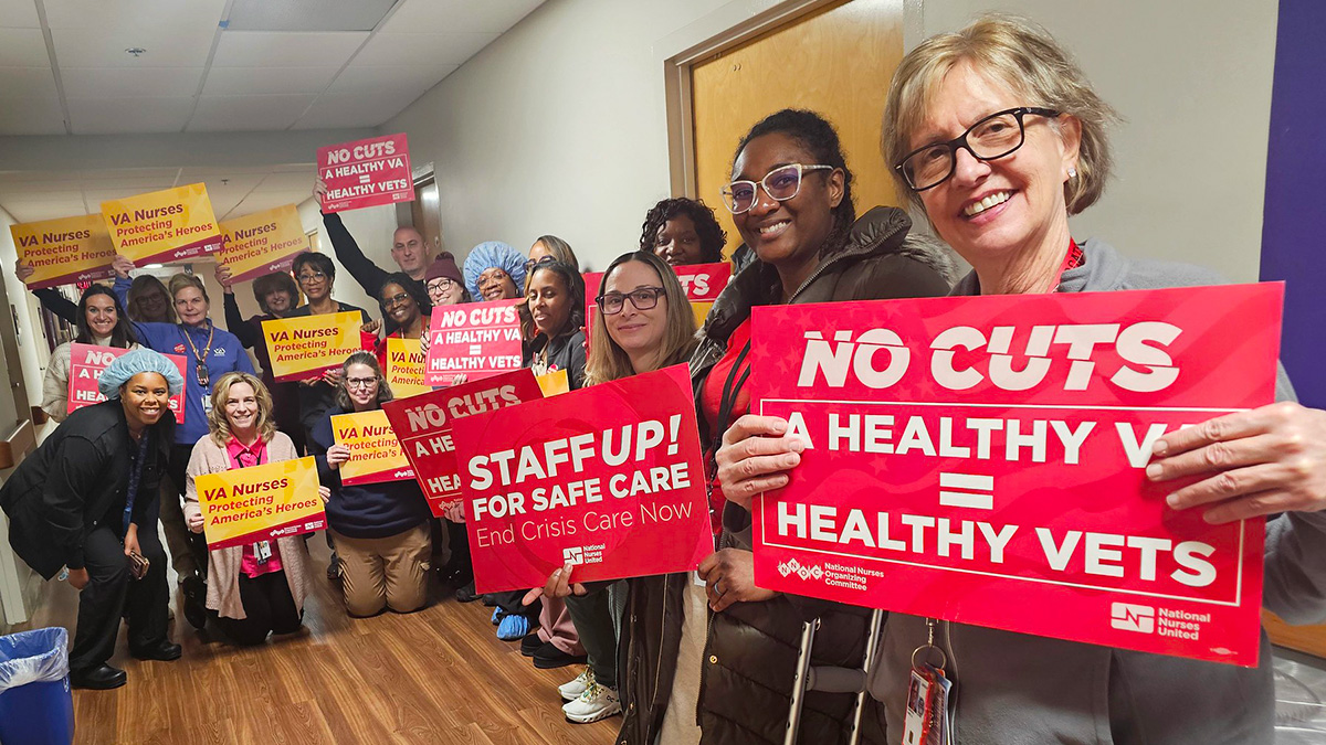 Nurses in hallway holding signs "No Cuts: A Healthy VA = Healthy Vets"