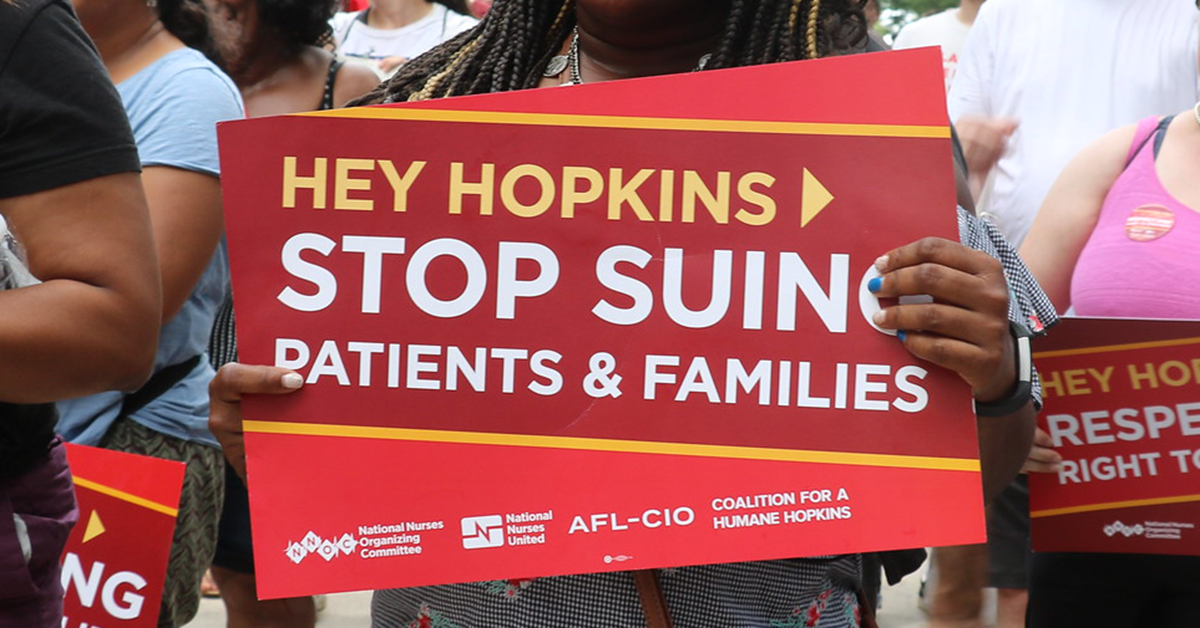 Signs "Hey Hopkins > Stop Suing Patients & Families"