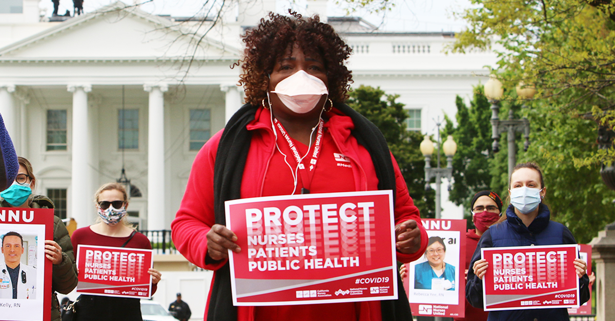 Nurses with signs in front of capitol "Protect Nurses, Patients, Public Health"