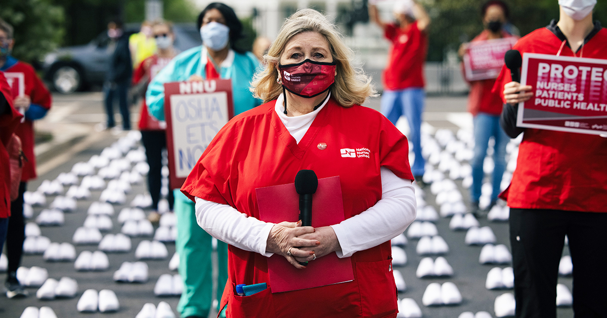 Nurses at National Day of Remembrance standing among over 400 pairs of white shoes in front of capitol building.