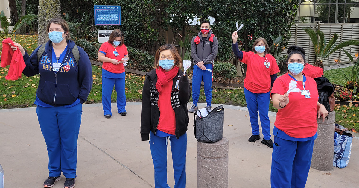 Group of nurses holding rally outside hospital 