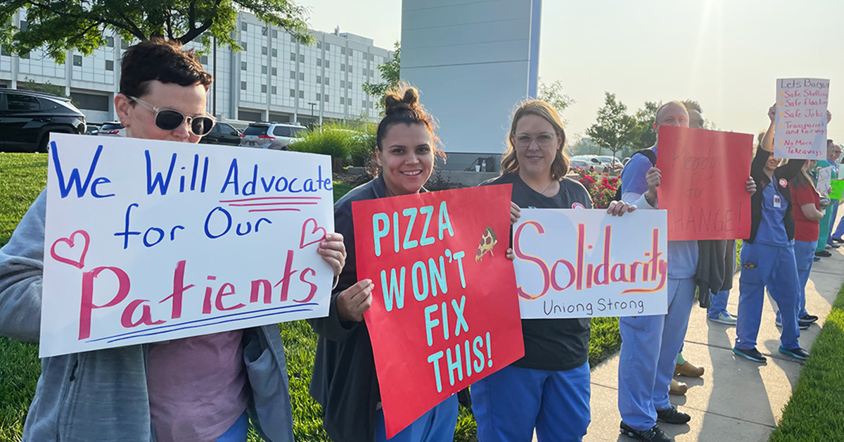 Nurses in front of Ascension Via Christi St. Joseph hospital holding picket