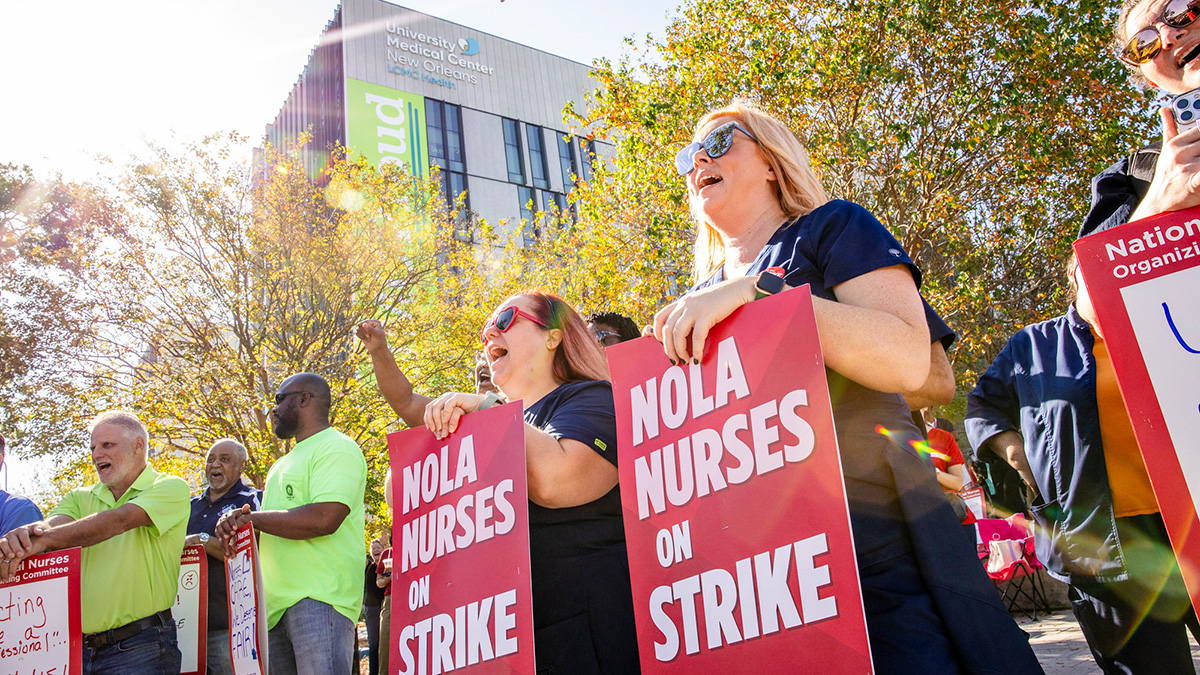 Nurses outside of UMC hospital holding signs "NOLA Nurses On Strike"