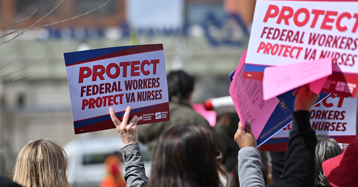 Hand holding sign "Protect Federal Workers, Protect VA Nurses"