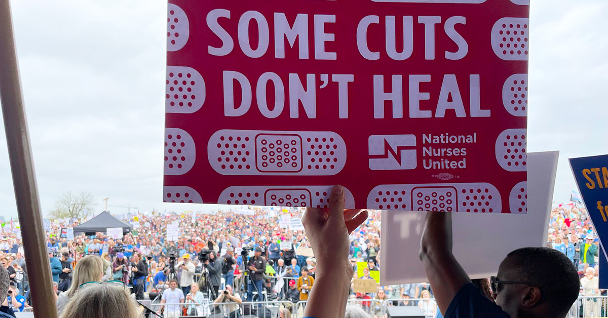 Hand holding sign "Some Cuts Don't Heal"