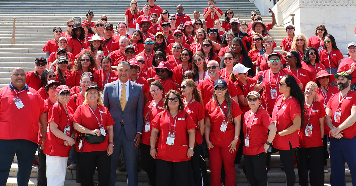 Nurses stand on D.C. Capitol steps with Senator Padilla