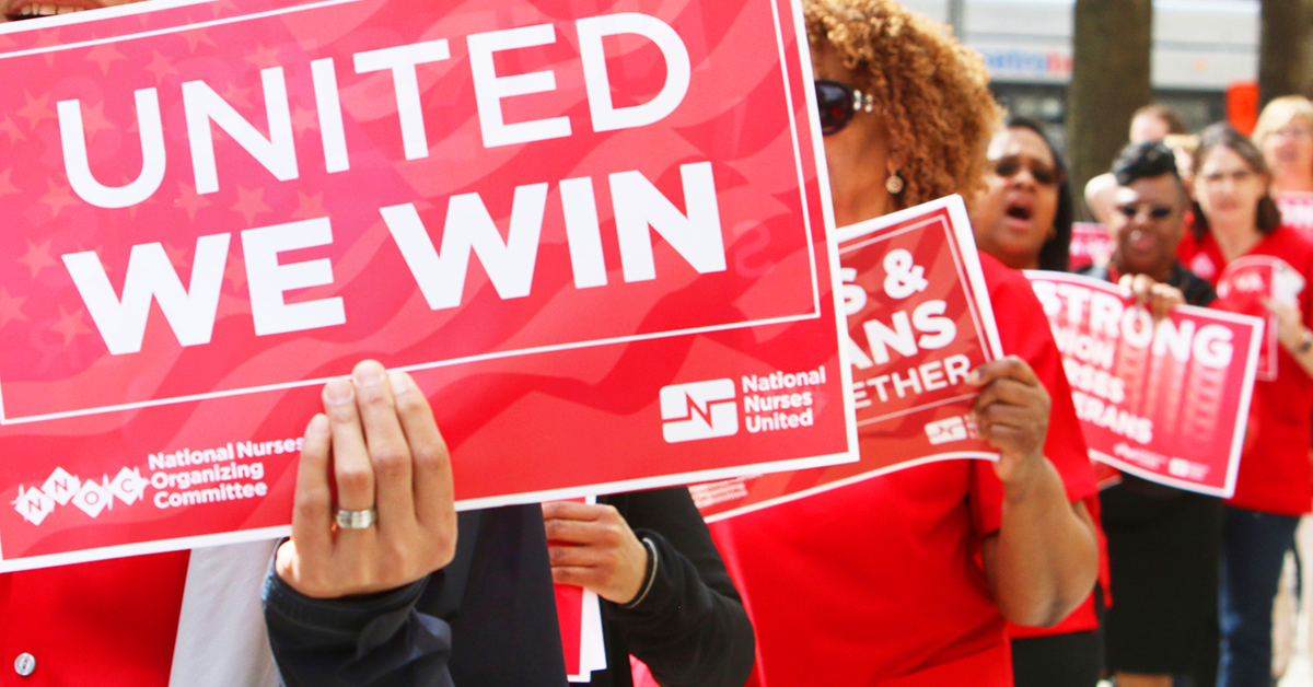 Nurses marching and holding sign "United we win"