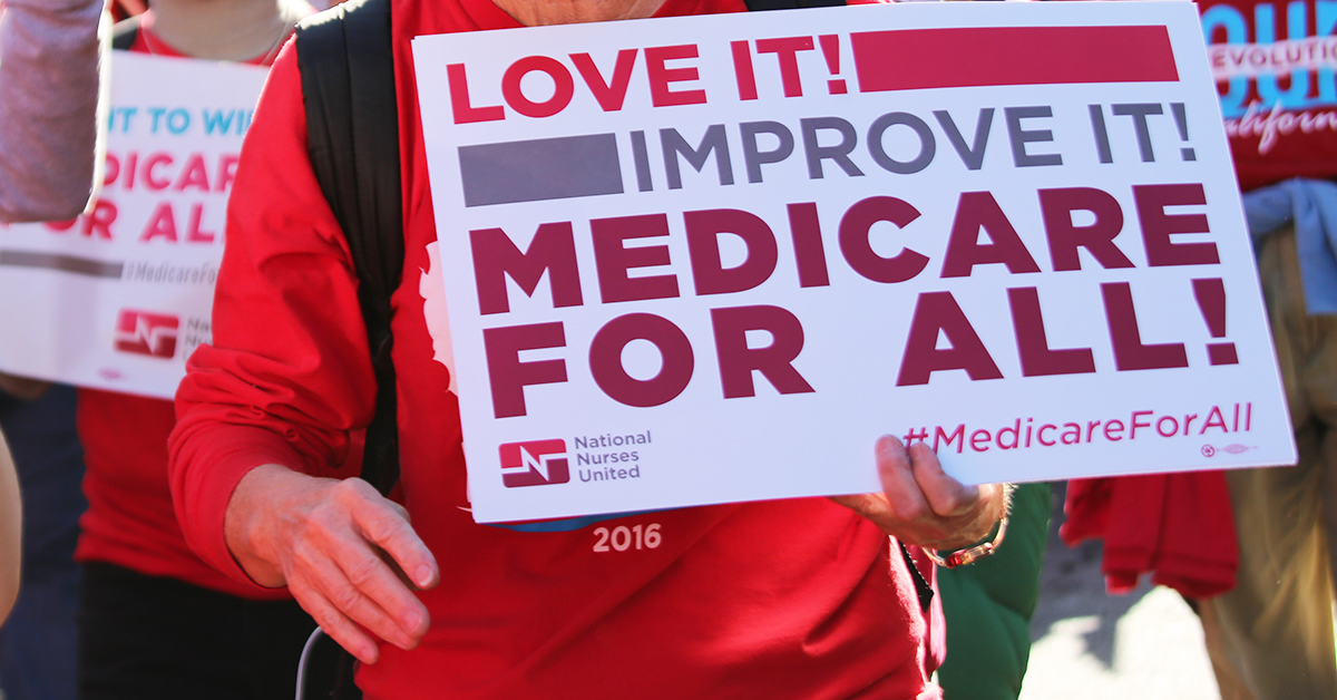 Person holding sign: "Love it, improve it, Medicare for All!"